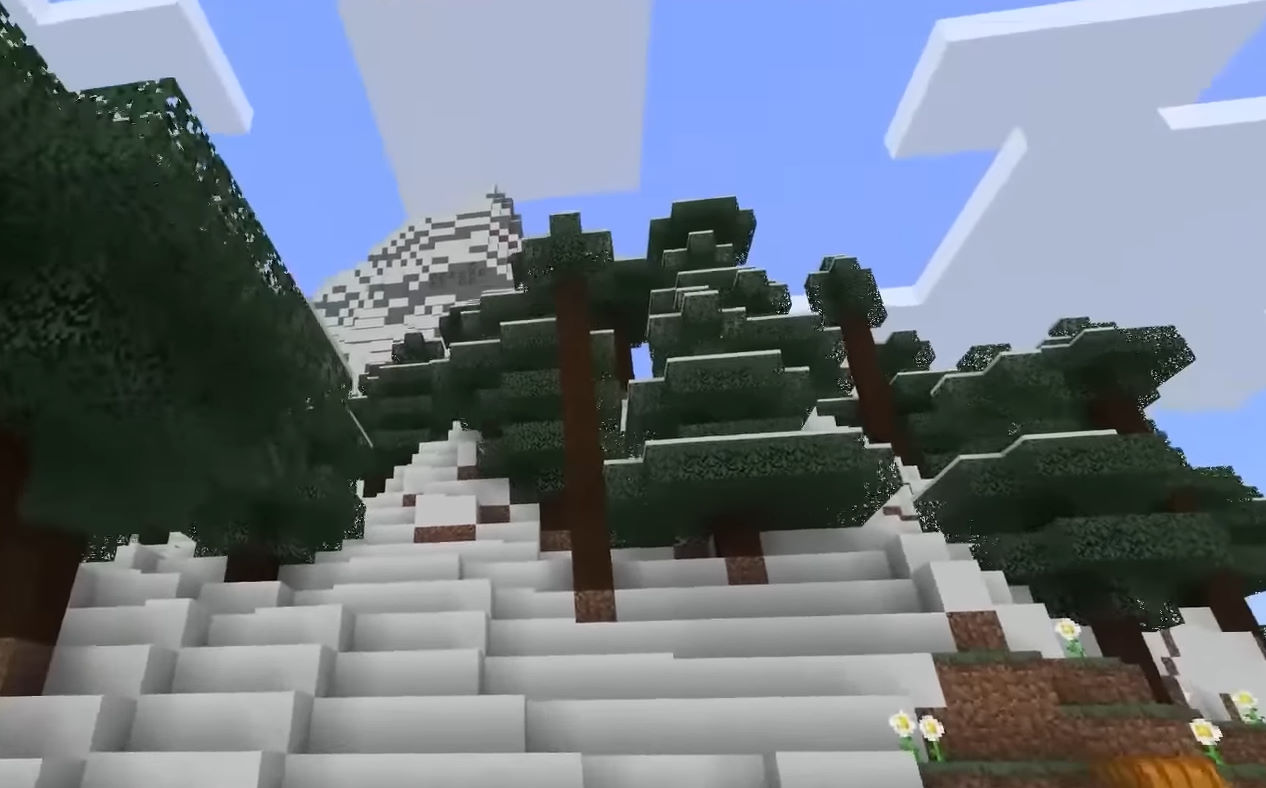 Настоящий игровой кадр Minecraft: заснеженные ели, горный склон и блочное небо